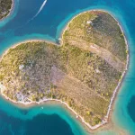 An aerial shot of a heart shaped island in Croatia