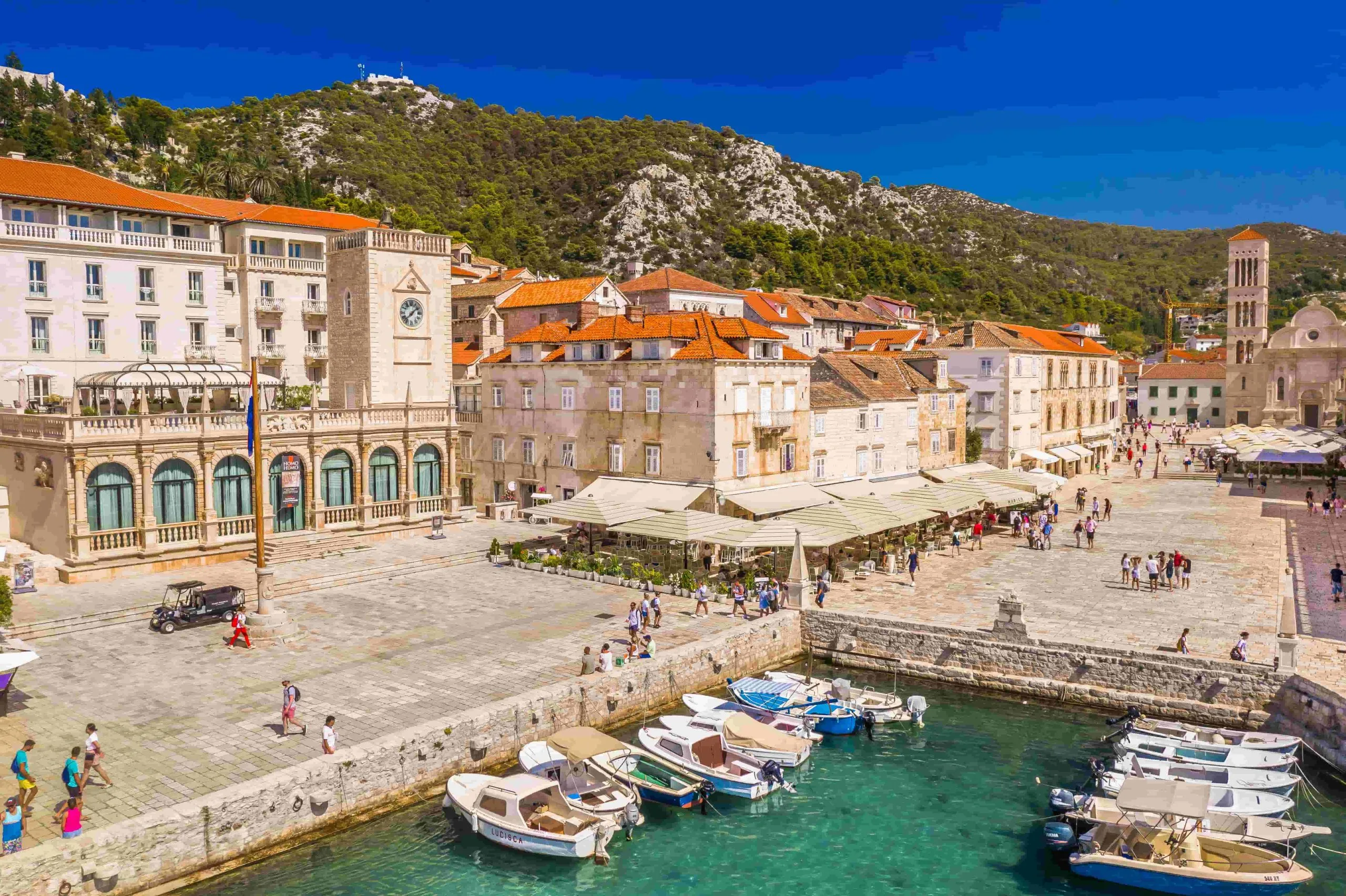 Hvar promenade and small port with a few boats
