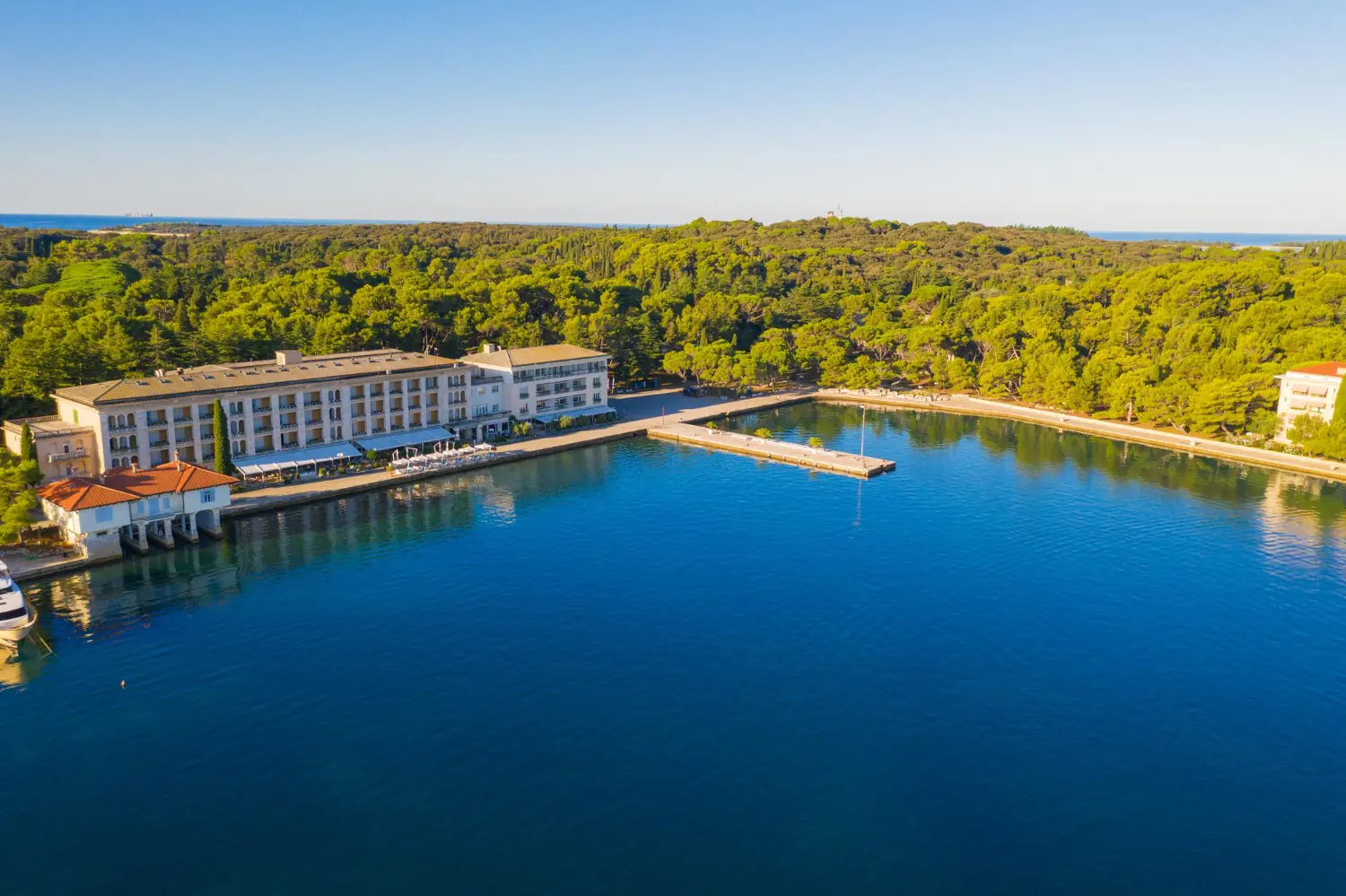 Aerial view of the coastline and a hotel complex by a calm bay on Brijuni.