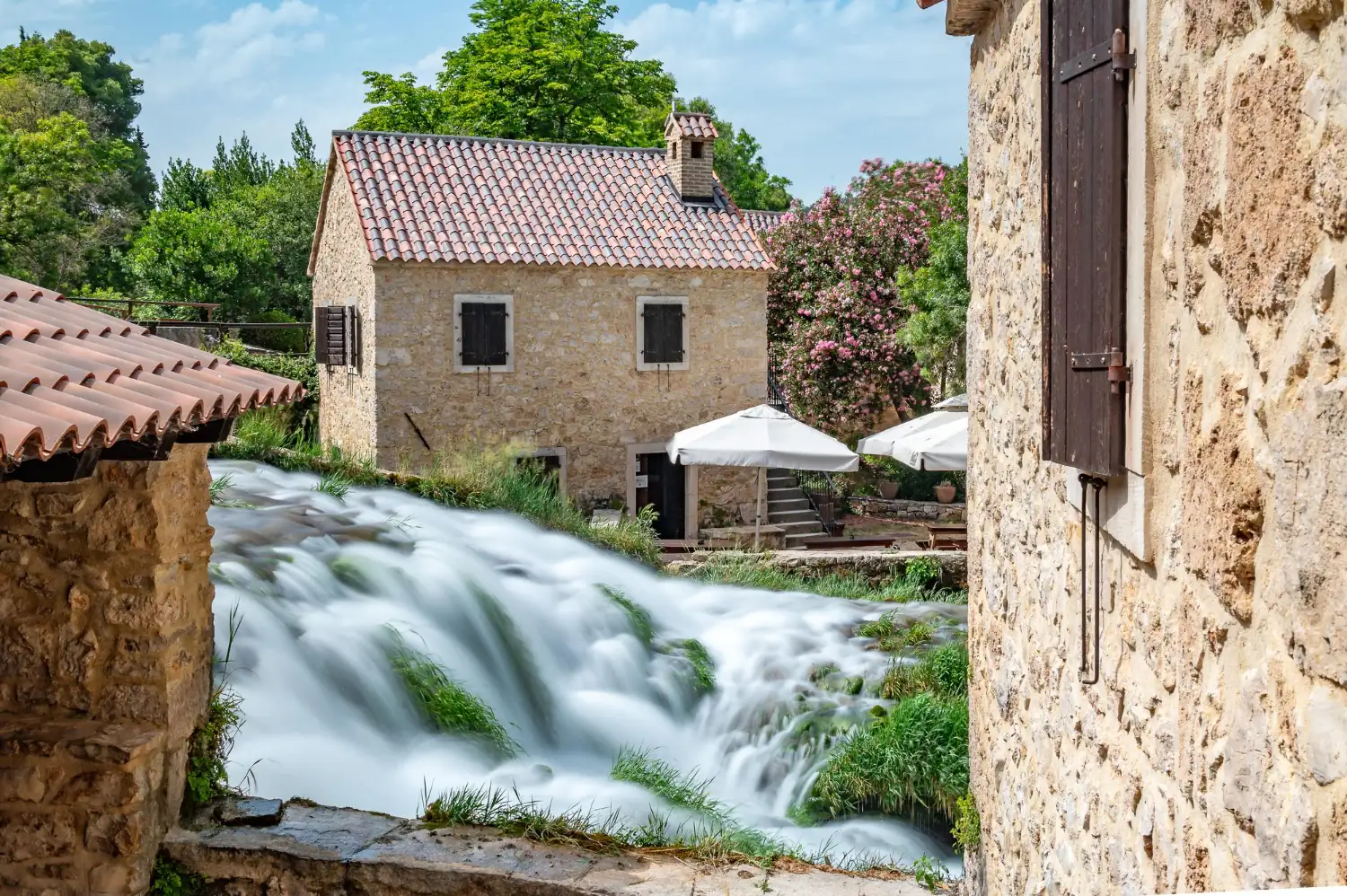 Traditional stone watermill on the Krka River with rapids and an ethno village - Krka National Park