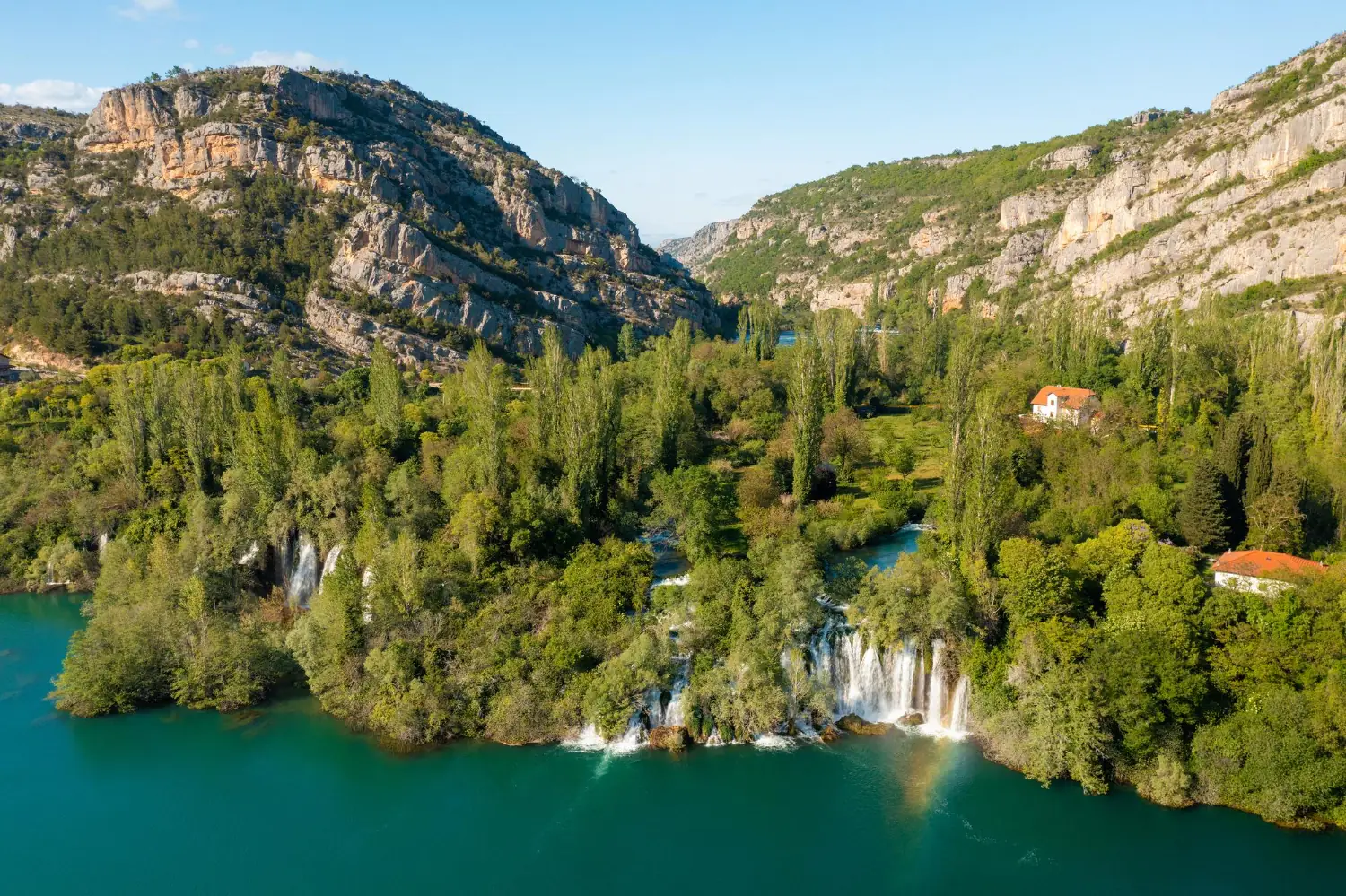 Waterfall in the Krka River canyon - aerial view of Ogrlice cascades and the emerald river among rocks